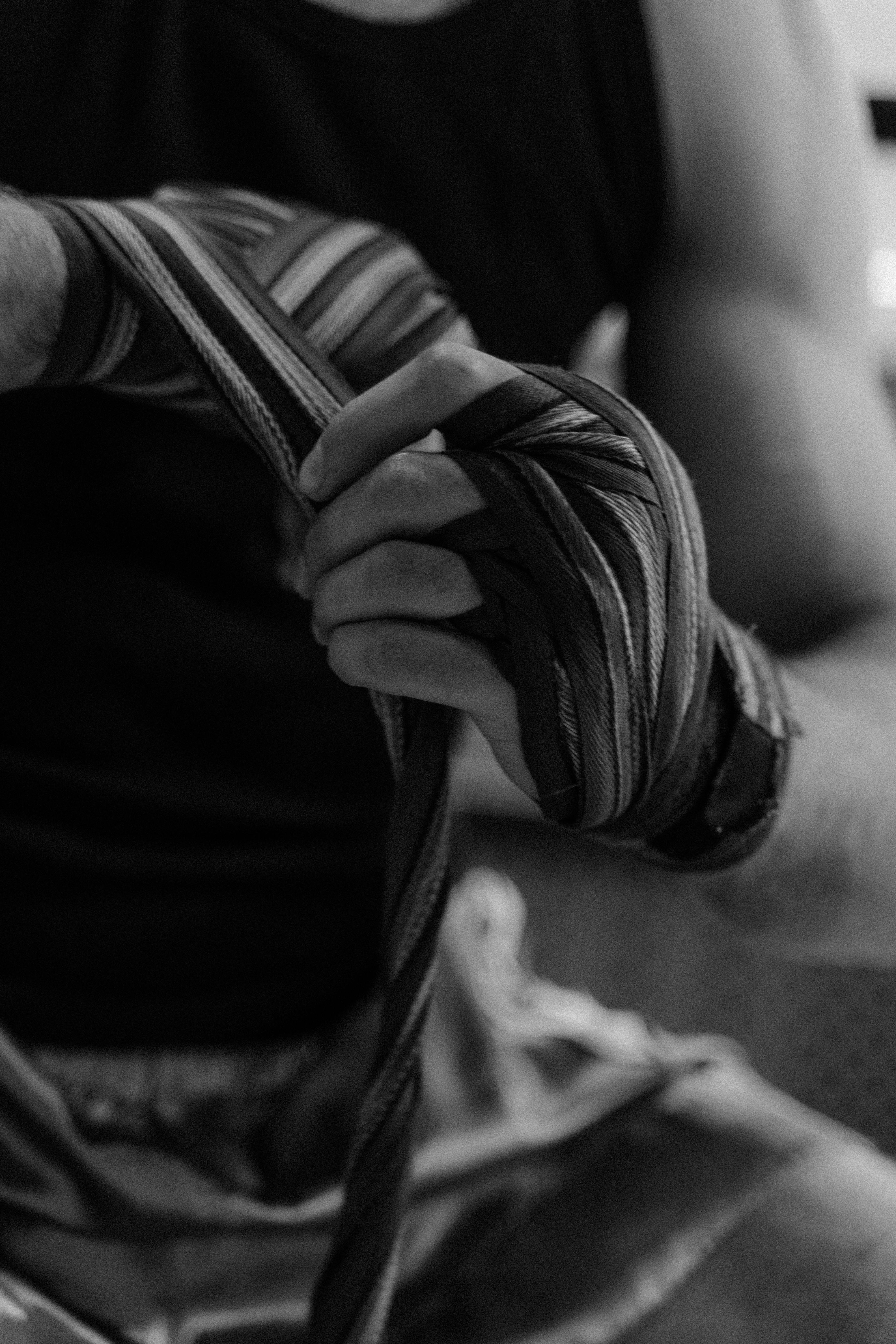 grayscale photo of a person with hand wraps