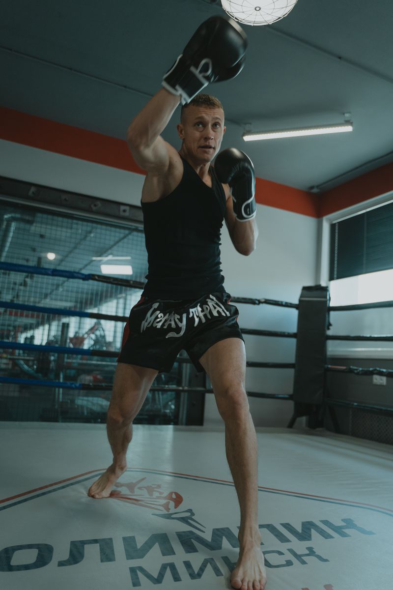 Kickboxer practicing shadow boxing in a boxing ring