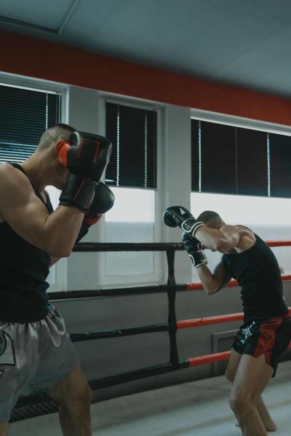 Boxers sparring in a gym ring