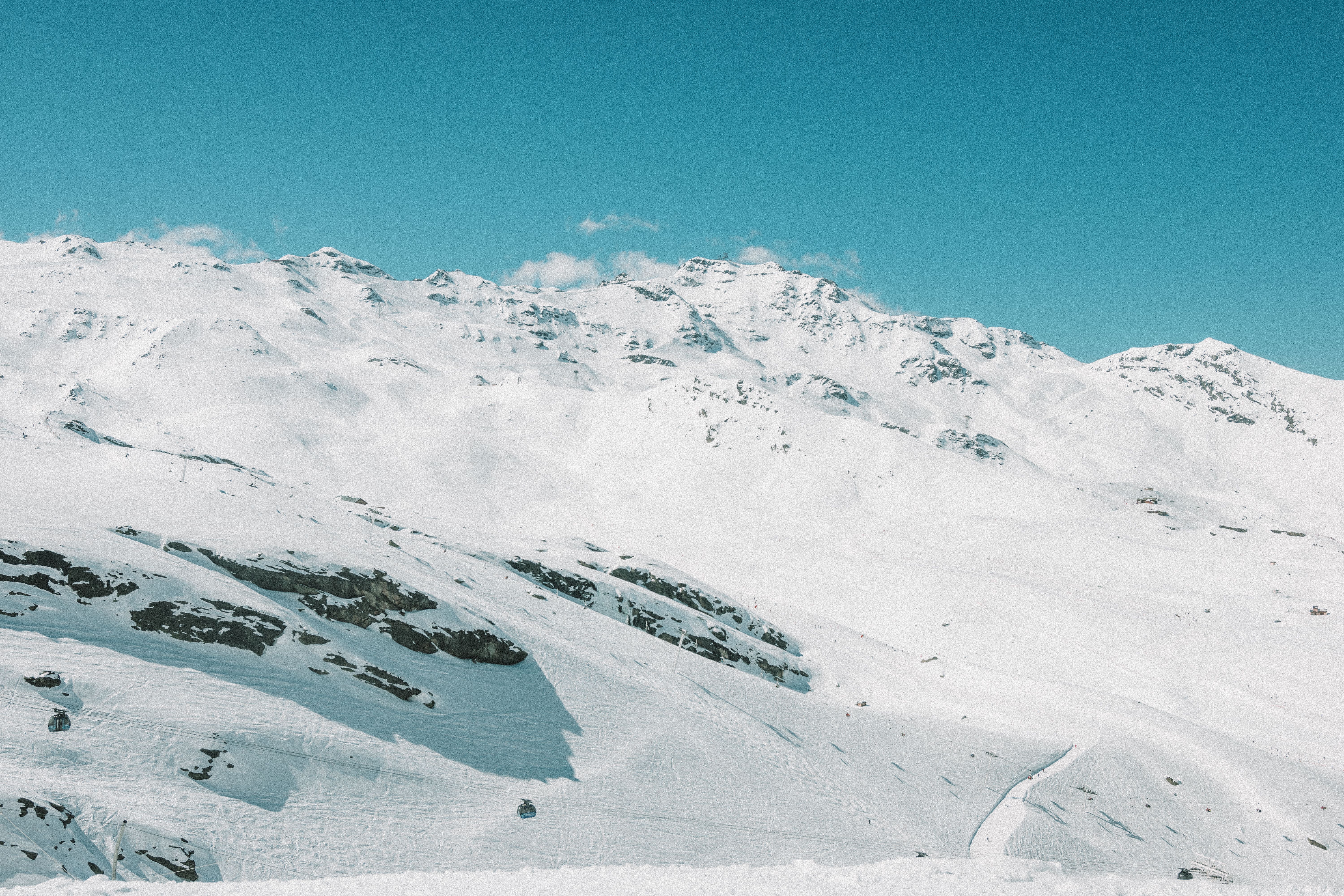Breathtaking snowy mountain scenery in Les Belleville, France, under a clear blue sky.