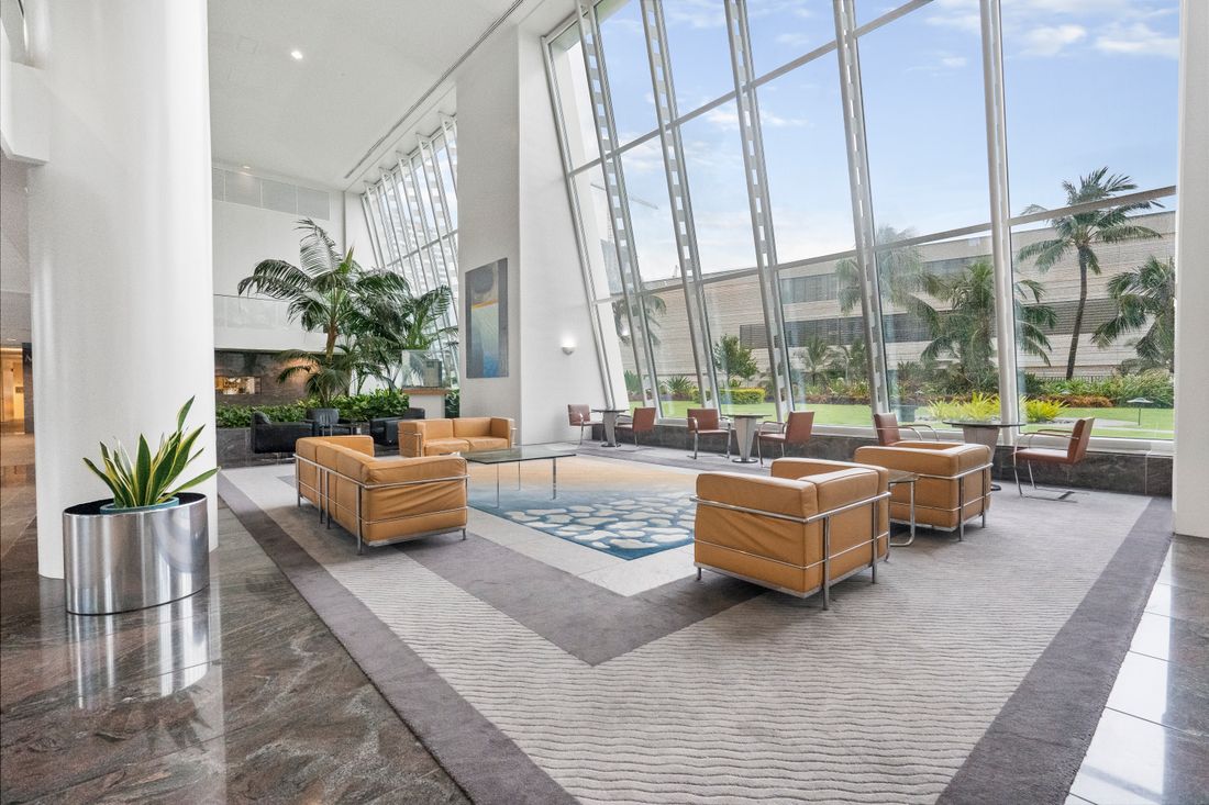 Commercial office lobby with a large clean area carpet and lounge seating