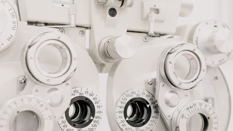 Contemporary medical optician clinical testing machine for checking eyesight in diagnostic center against white background