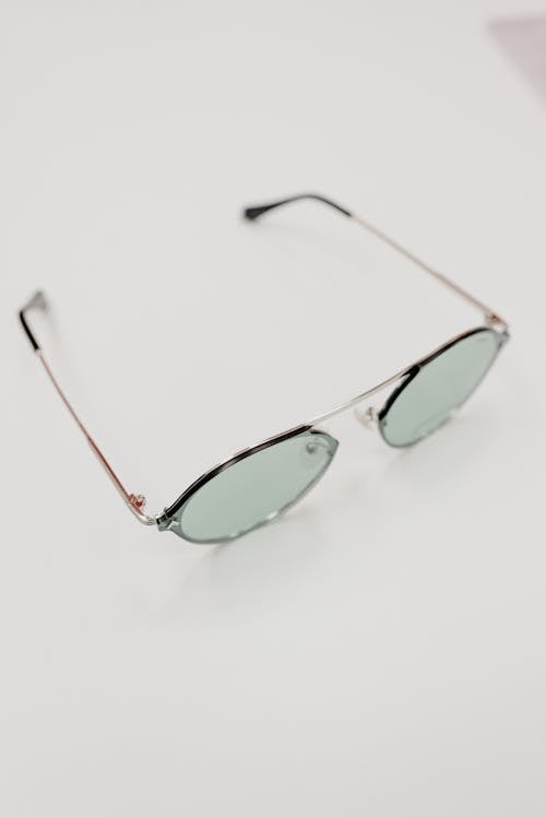 From above of contemporary sunglasses with lenses placed on white table in optical shop