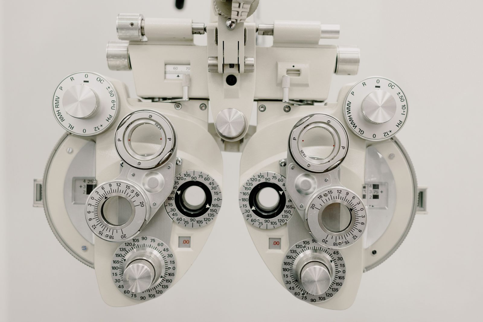 A close view of the lenses and dials of an eye examination instrument