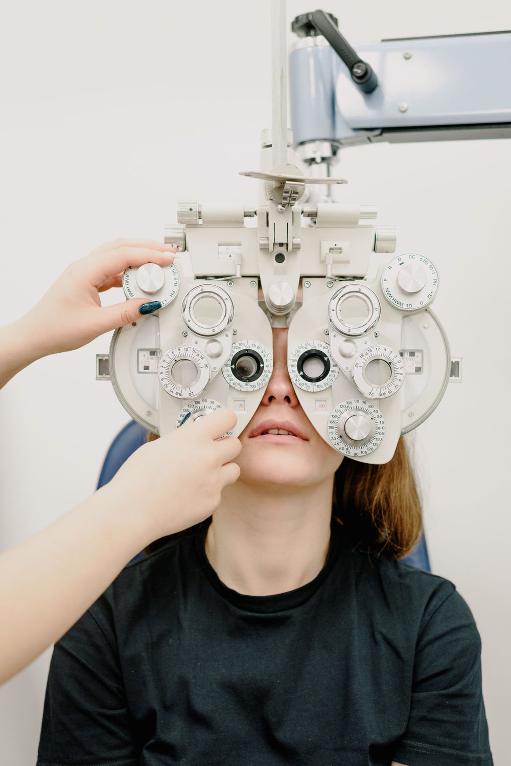 Dr. Mercer examining a patient's eyes with clinical equipment