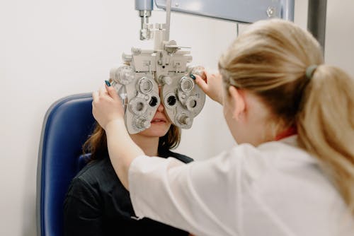 Unrecognizable ophthalmologist checking vision of patient