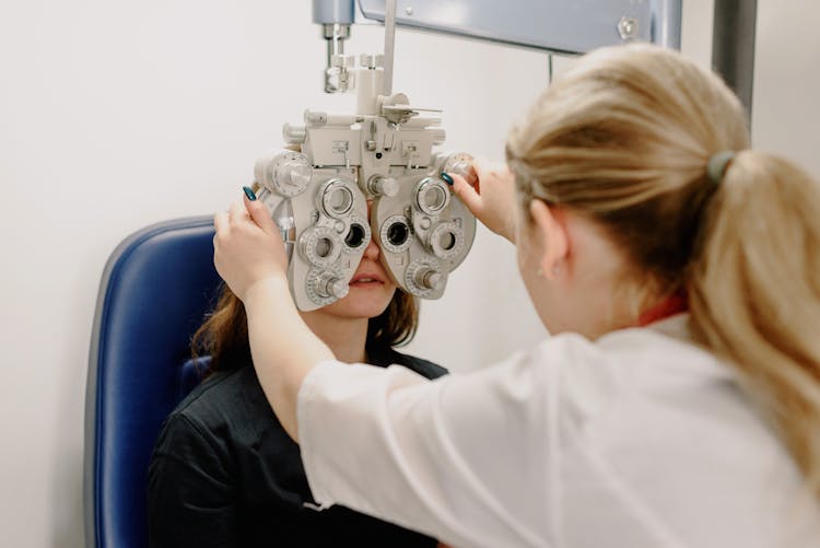 Unrecognizable Ophthalmologist Checking Vision Of Patient