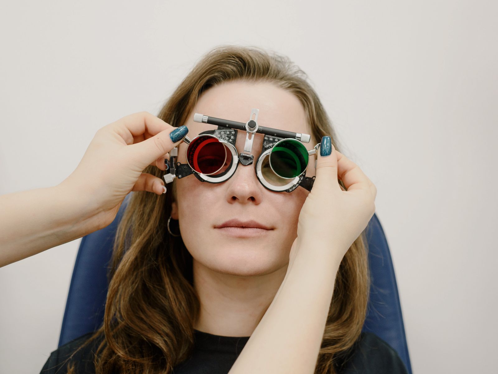 A female eye doctor selecting lenses for a female patient during an appointment