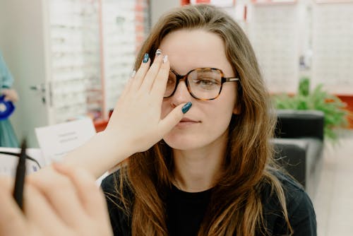 Free Crop oculist covering eye of woman Stock Photo