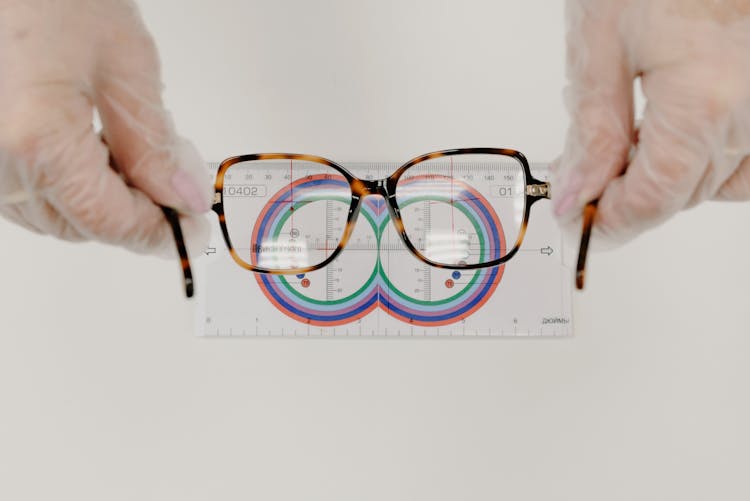 Crop Ophthalmologist Measuring Eyeglasses With Lens Ruler