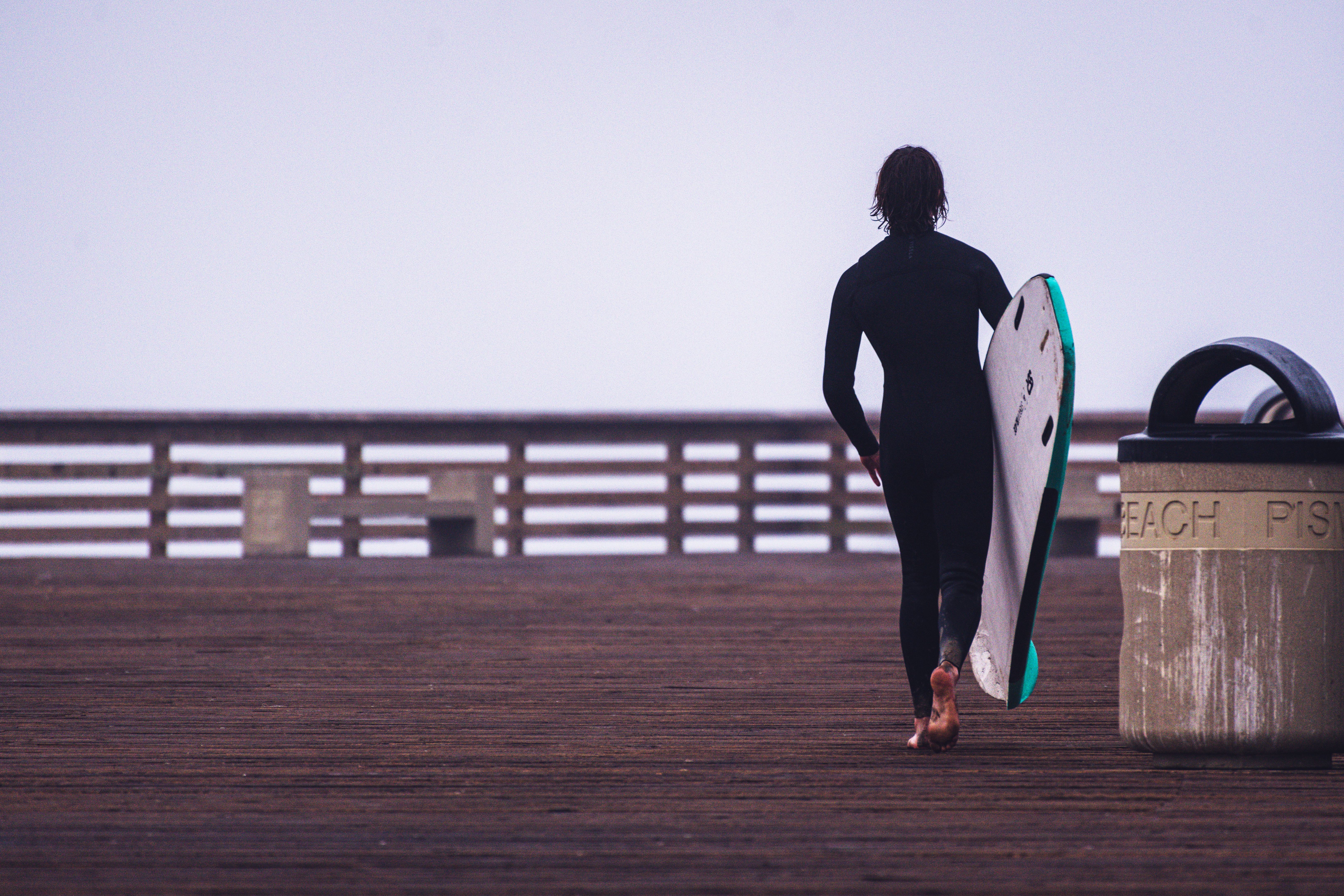 A Woman in Black Wetsuit Standing while Carrying a Surfboard · Free ...
