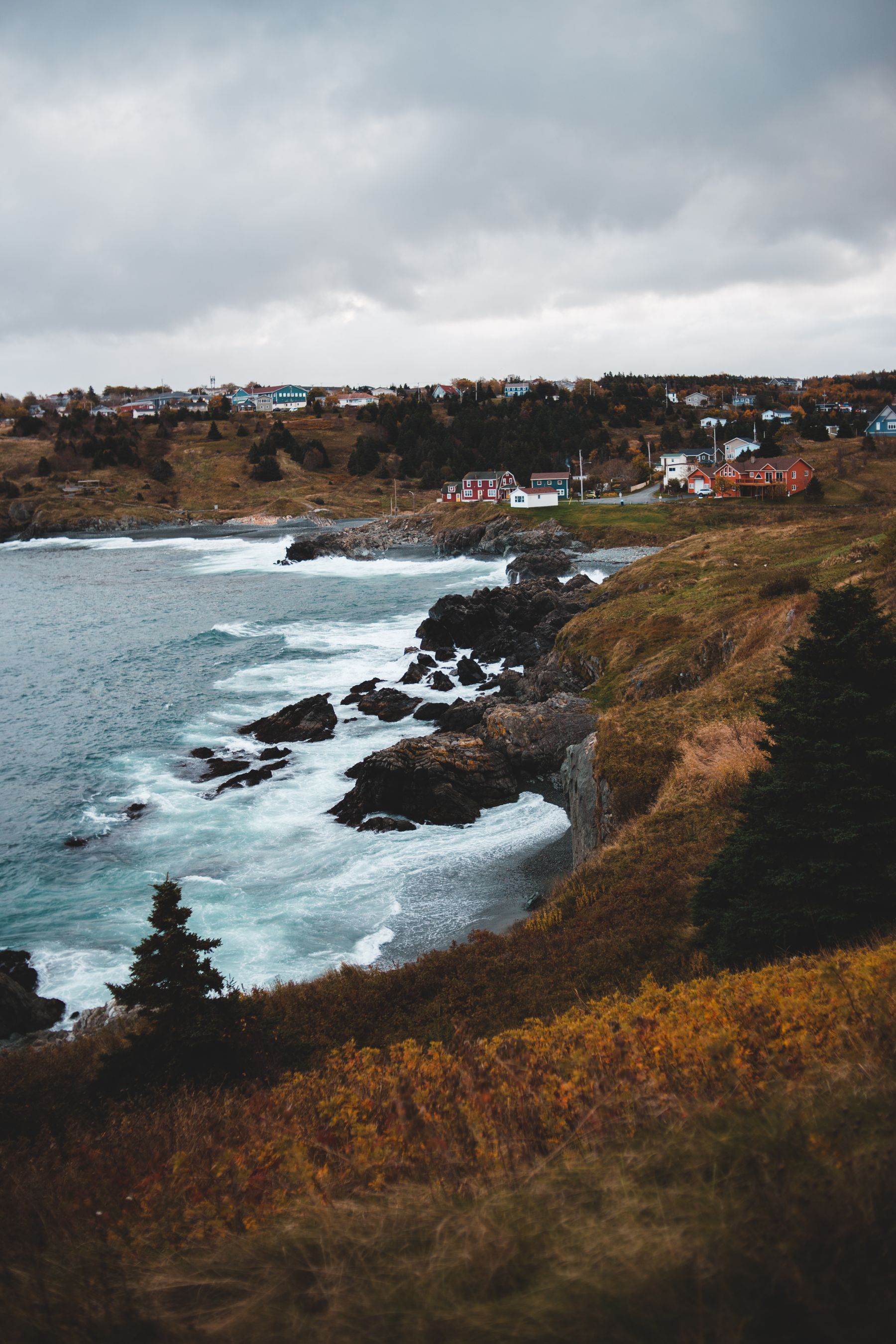 Waves breaking against a rocky coast in gloomy weather