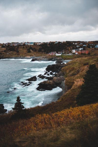 Waves breaking against a rocky coast in gloomy weather