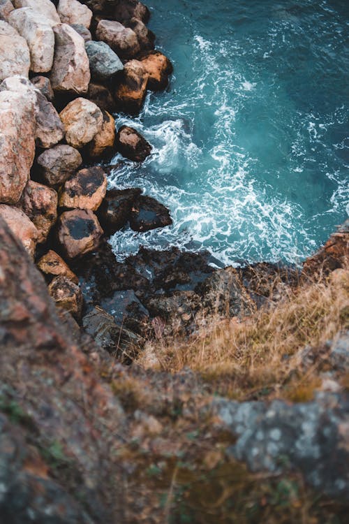 Stormy sea waving near rocky coast