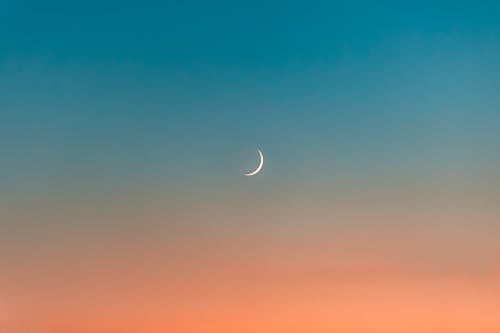 Crescent Moon in the Blue and Orange Sky