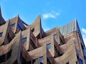 在晴朗的蓝天下，这座未来派建筑设计具有尖锐的角度和引人注目的立面