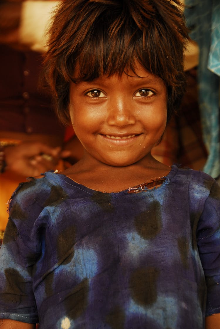 Smiling Kid Wearing Tattered Shirt 