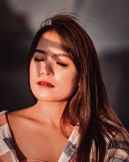 Calm woman with shadow on face