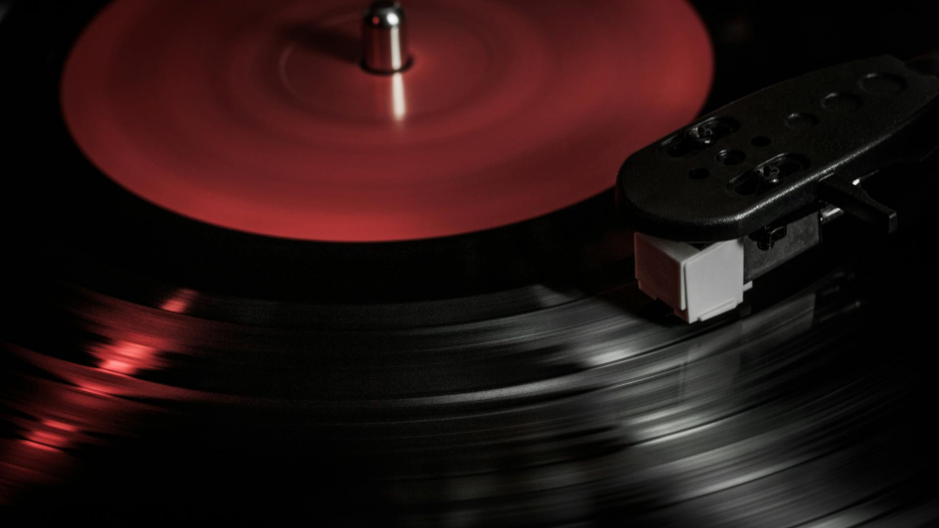 A close-up shot of a vinyl record spinning on a vintage player, highlighting the retro phonograph aesthetic.