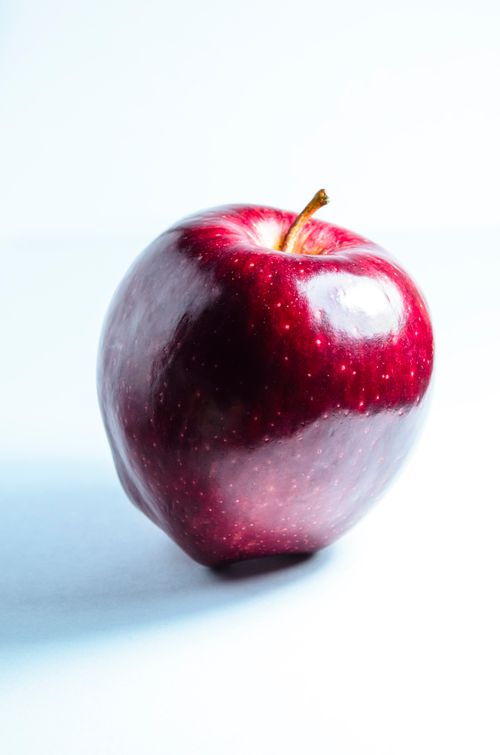 Free High-quality image of a fresh, shiny red apple with a white background. Stock Photo