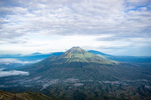 Volcanic mountain peak under cloudy sky