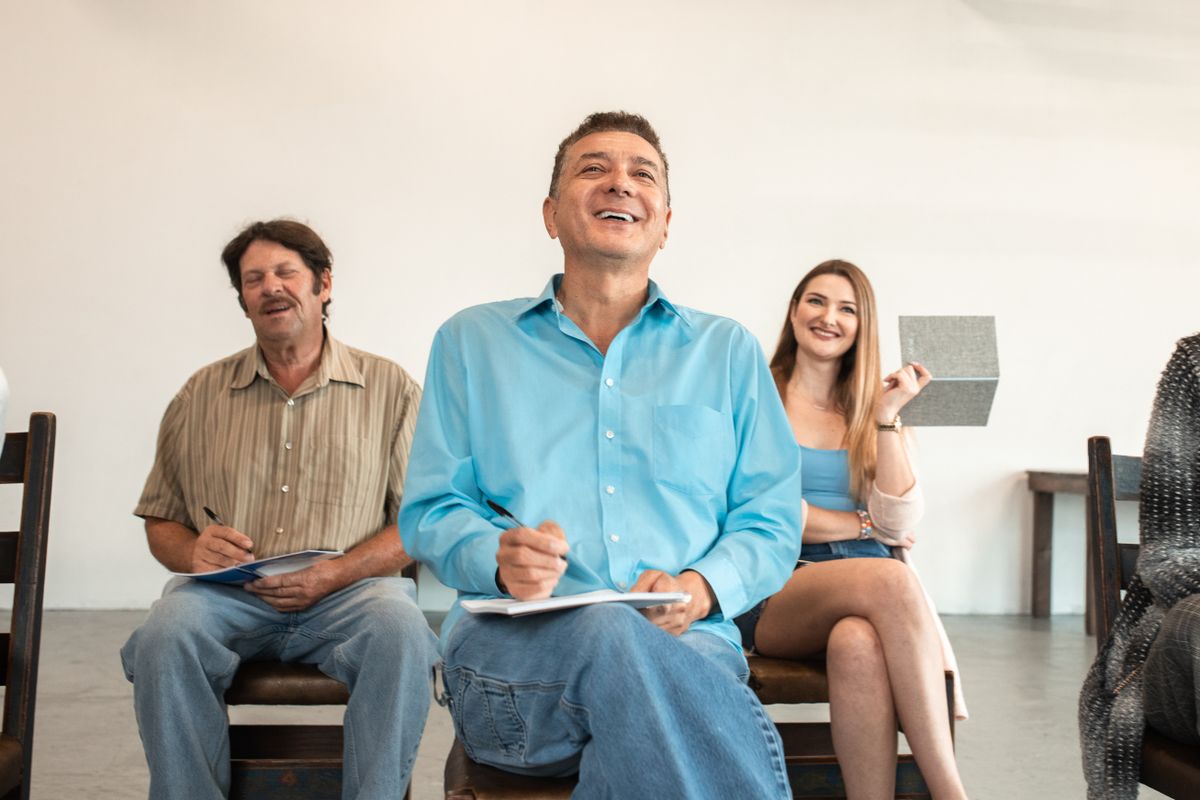 Adultes en formation professionnelle prenant des notes en salle