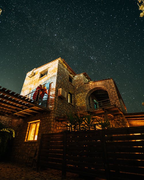 A Brick House Under a Starry Night Sky