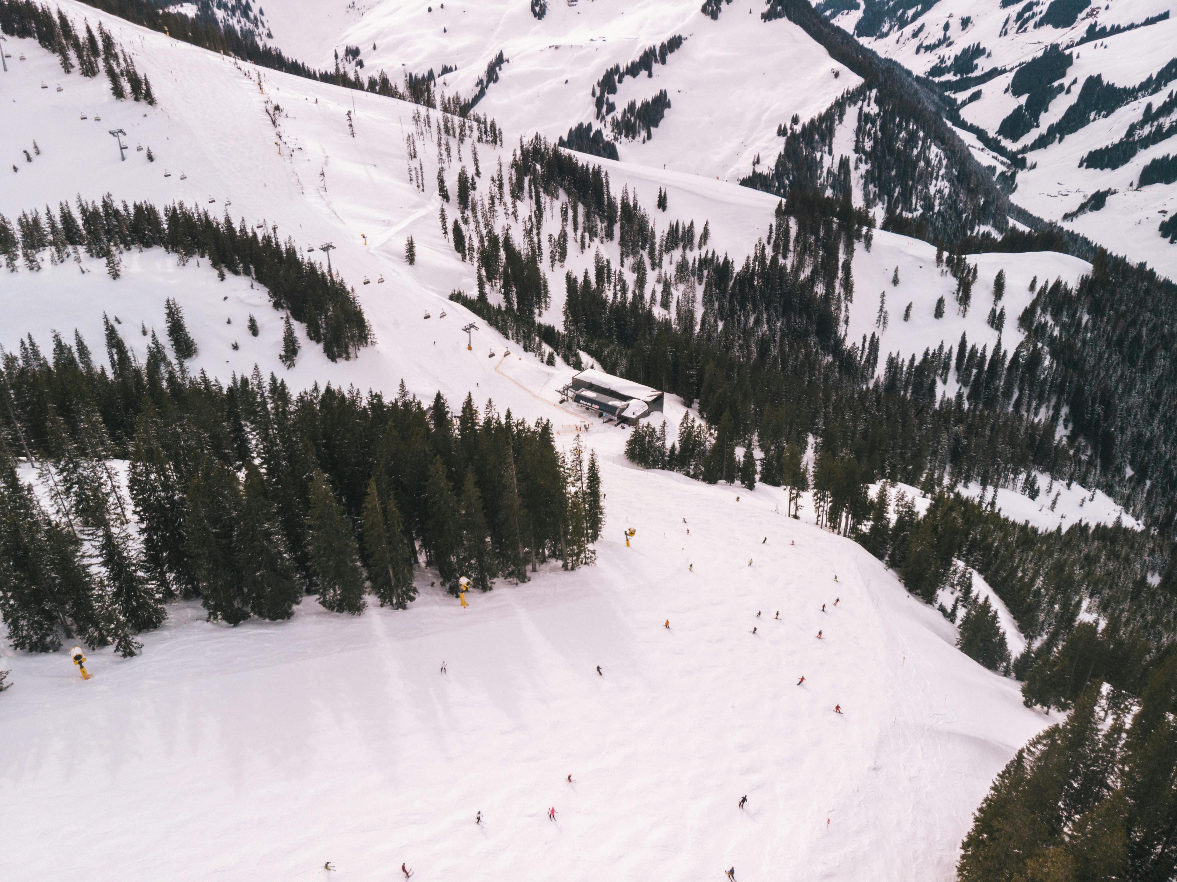 Prescription Goggle Inserts - Aerial shot of a snow-covered ski resort with pine trees in Austria during winter.