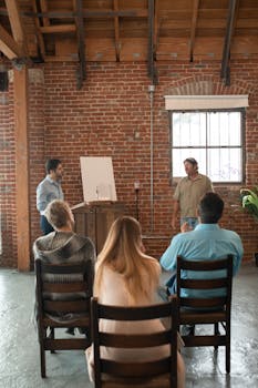 Adults attending a casual learning session in a rustic brick interior.