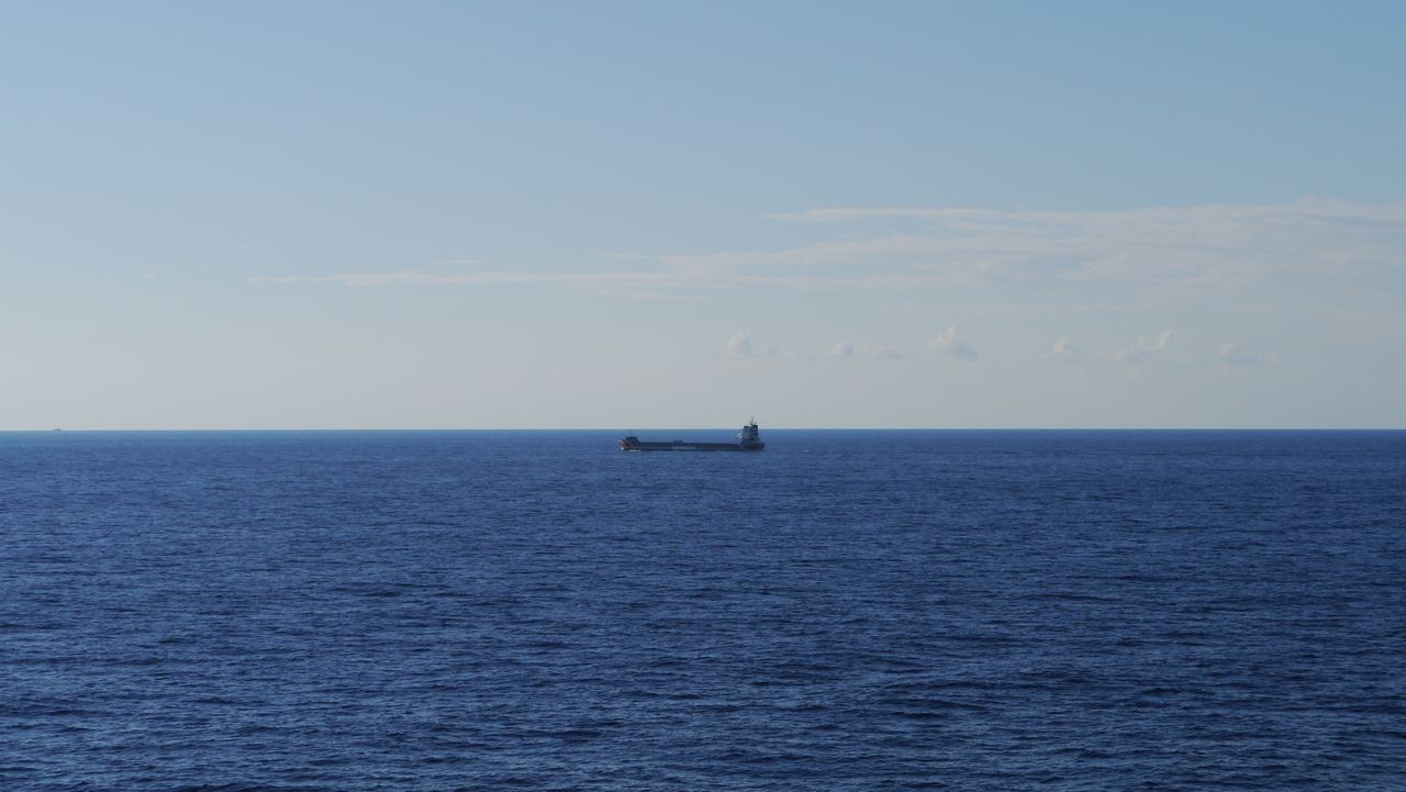 a tranquil scene of a bulk carrier ship cruising across a vast open oc