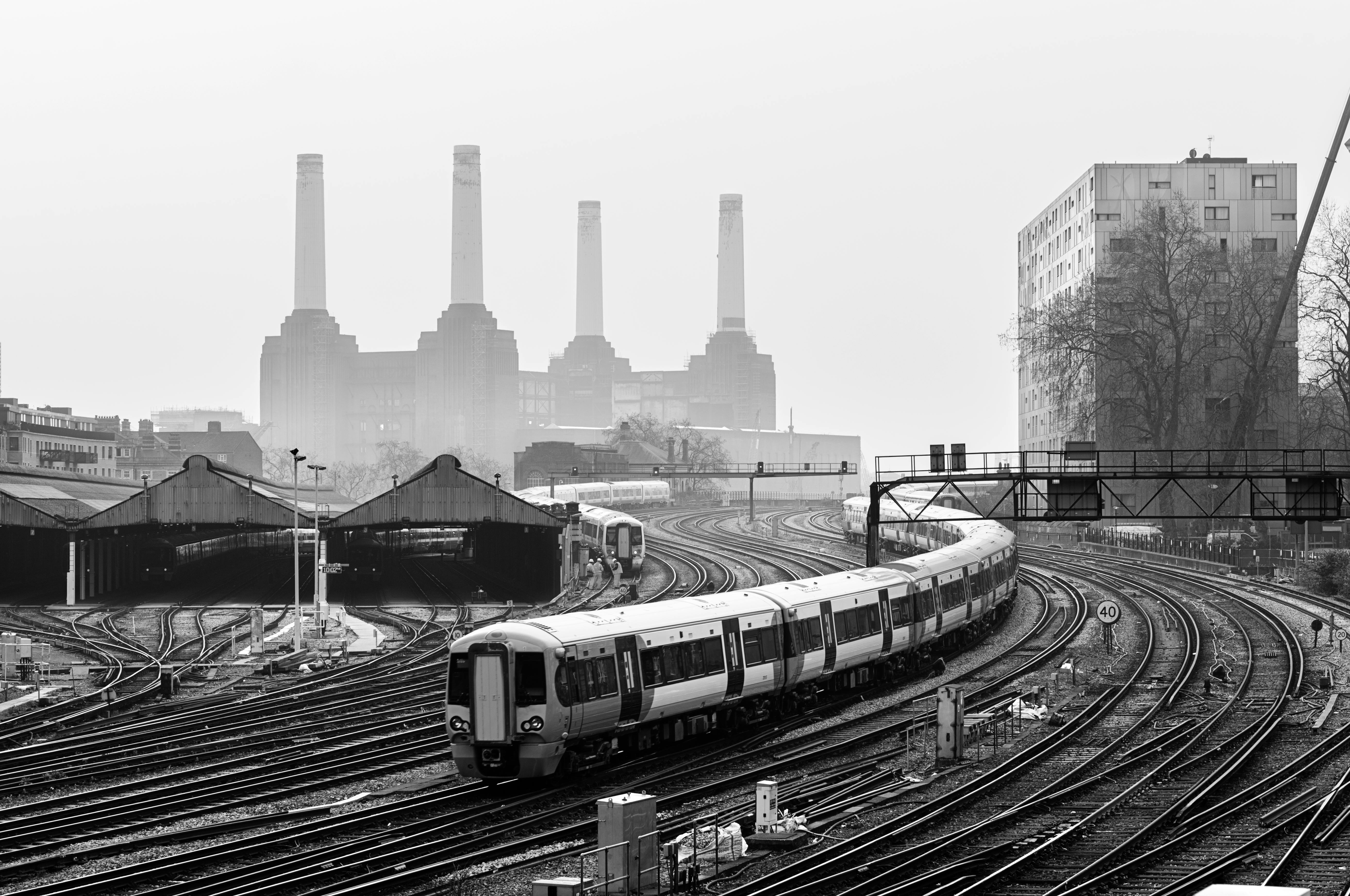 Free Monochrome image of trains and tracks near Battersea Power Station, London. Stock Photo