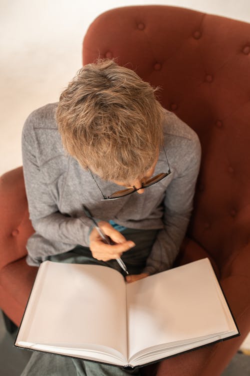 A Woman Holding a Pen and a Notebook