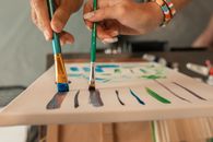 People Holding A Paint Brush