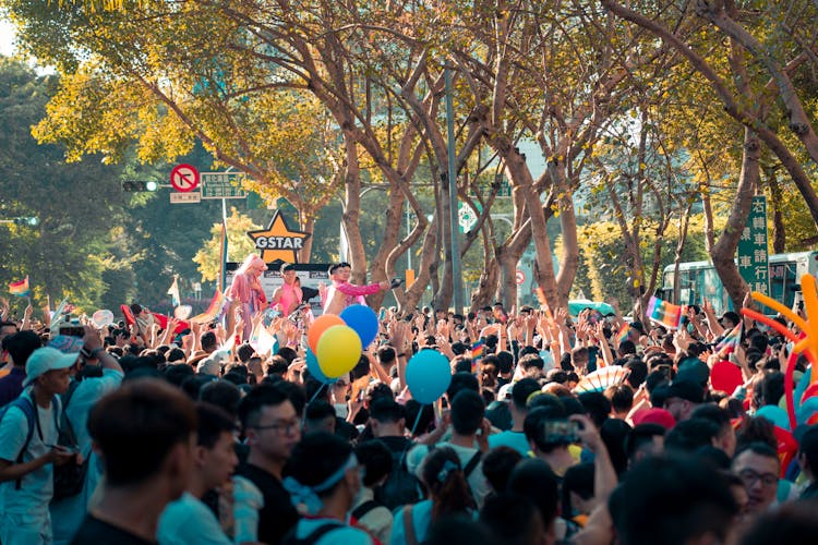 Anonymous Ethnic People With Closed Arms During Festival On City Street