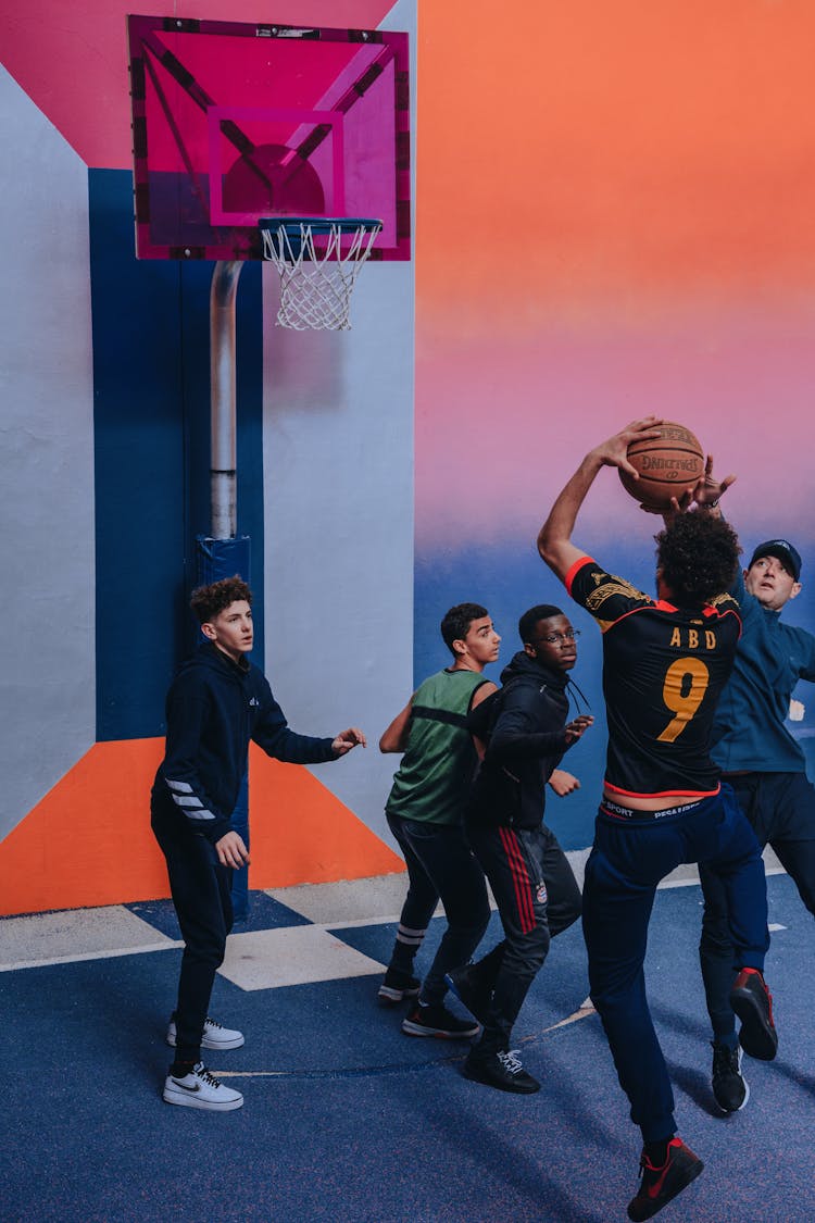 Diverse Men Playing Basketball On Playground