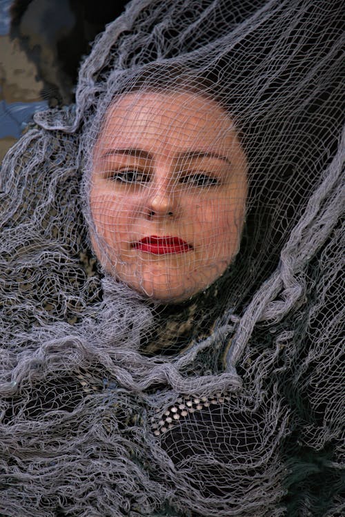 A Woman Covered in Mesh Net Fabric