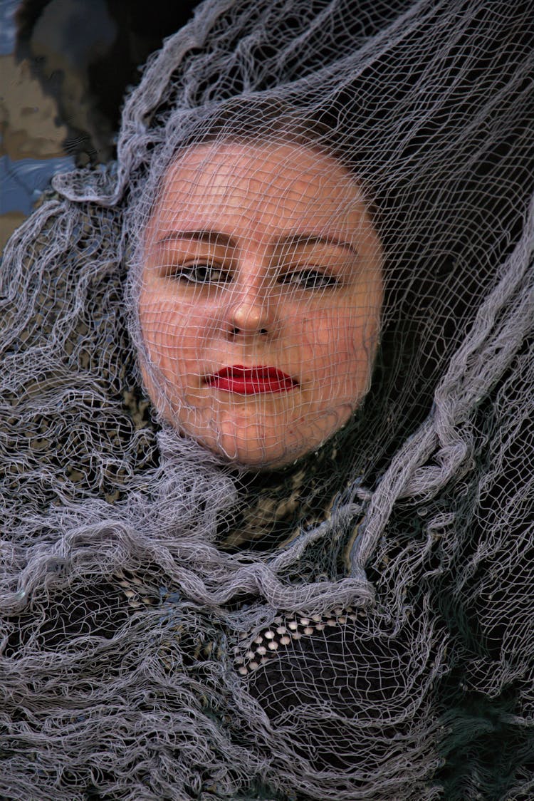 A Woman Covered In Mesh Net Fabric