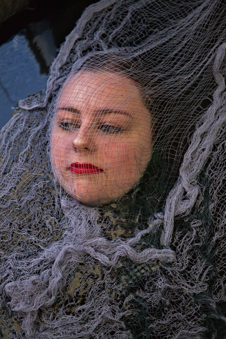 A Woman Covered In Mesh Fabric