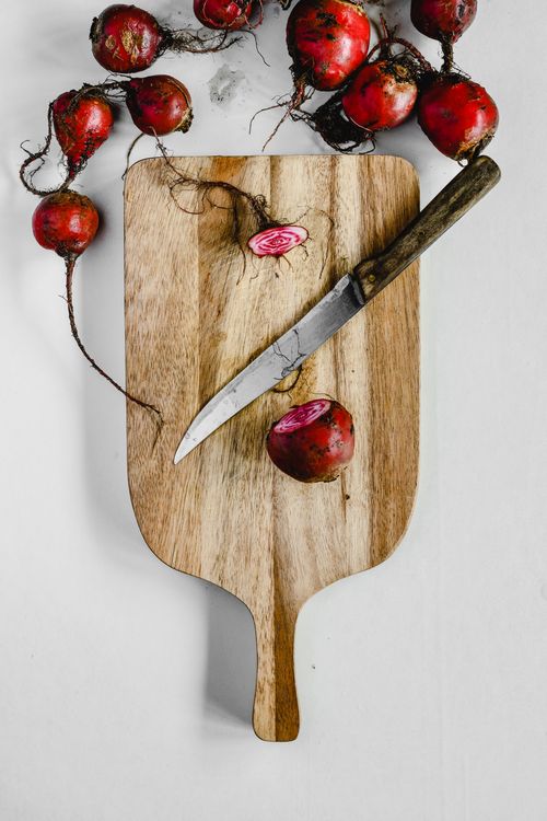 Free Chioggia beets with distinct rings on a wooden cutting board, knife beside, top view. Stock Photo