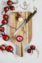 Cutting Beet Roots on a Wooden Chopping Board