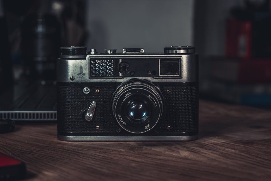 Free A Vintage Analog Camera over the Wooden Table Stock Photo