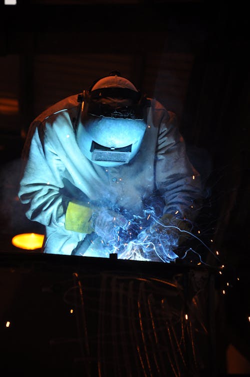 A Person Welding a Metal