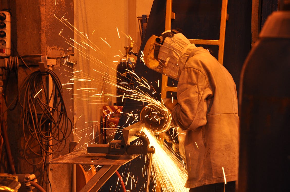 Free A Person Standing Near the Grinder Stock Photo