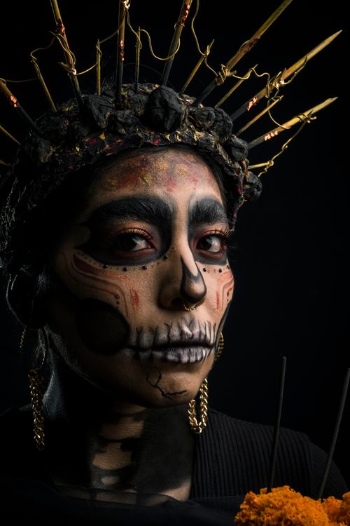 Free Stunning Day of the Dead portrait featuring intricate face art and crown on a woman. Stock Photo