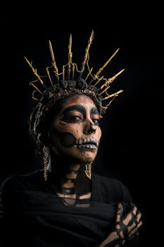 A woman in Day of the Dead skull makeup wearing a golden crown, embodying the spooky holiday spirit.