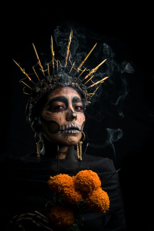 Free A striking portrait featuring dark makeup and a crown, inspired by Day of the Dead traditions. Stock Photo