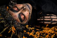 Man in Black Leather Jacket With Brown Dried Leaves on His Face