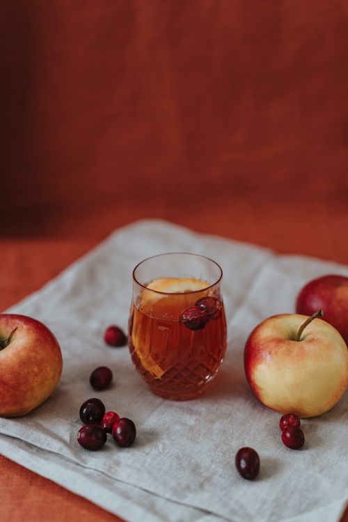 Free A delightful still life of a cranberry apple drink surrounded by fresh fruits. Stock Photo