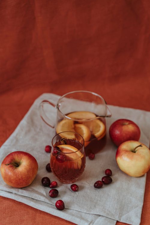Free Warm still life of apple and cranberry tea with fresh fruits and cozy vibes. Stock Photo