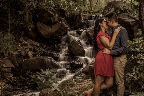 Couple Standing Near the Waterfalls